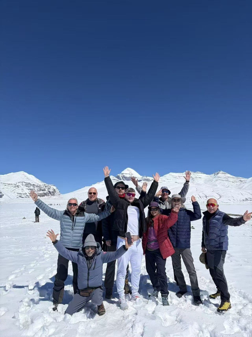 Group cheering with arms raised in the snow