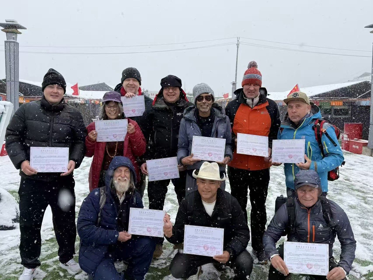 Tour group displaying certificates in the snow